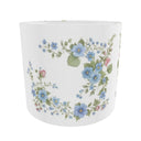 A white drum lampshade decorated with a delicate border of blue forget-me-nots, pink blossoms, and green leaves, shown against a plain white background.