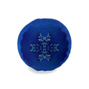The cobalt blue cylinder bolster cushion ,side view. Featuring a light blue snowflake design in the center, set against a plain white background.