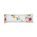 A long rectangular lumbar pillow with a white linen-textured background, decorated with a watercolor-style floral pattern featuring pink, yellow, and white lilies with green leaves