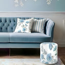 Blue and white hibiscus ottoman and cushion , styled on a blue sofa 