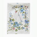 White blanket with blue and pink floral motif. 