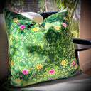 Green floral-patterned pillow on a cream armchair.