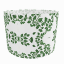 White drum lampshade with green leaf pattern on a white background. sideview.