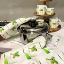 Gumleaf green and white oven gloves, choppingboard/ hot dish rest.