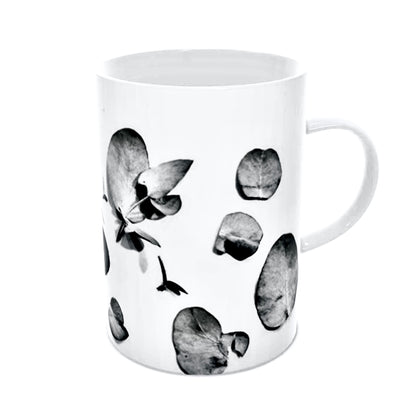 Zuko Gumleaf black and white mug. Perfect for outdoor gatherings or elegant indoor settings, the vibrant gum leaf design on a classic cup adds a touch of nature to any table. Side view