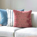 Rose taupe patterned velvet cushion styled with blue and white striped cushion. 