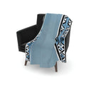 Savanna blue velvet throw blanket styled on armchair.