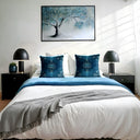Bedroom featuring two teal velvet cushions styled on a white bed with black side tables and black lamps 