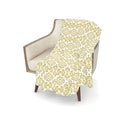 Yellow and white patterned velvet throw blanket.
